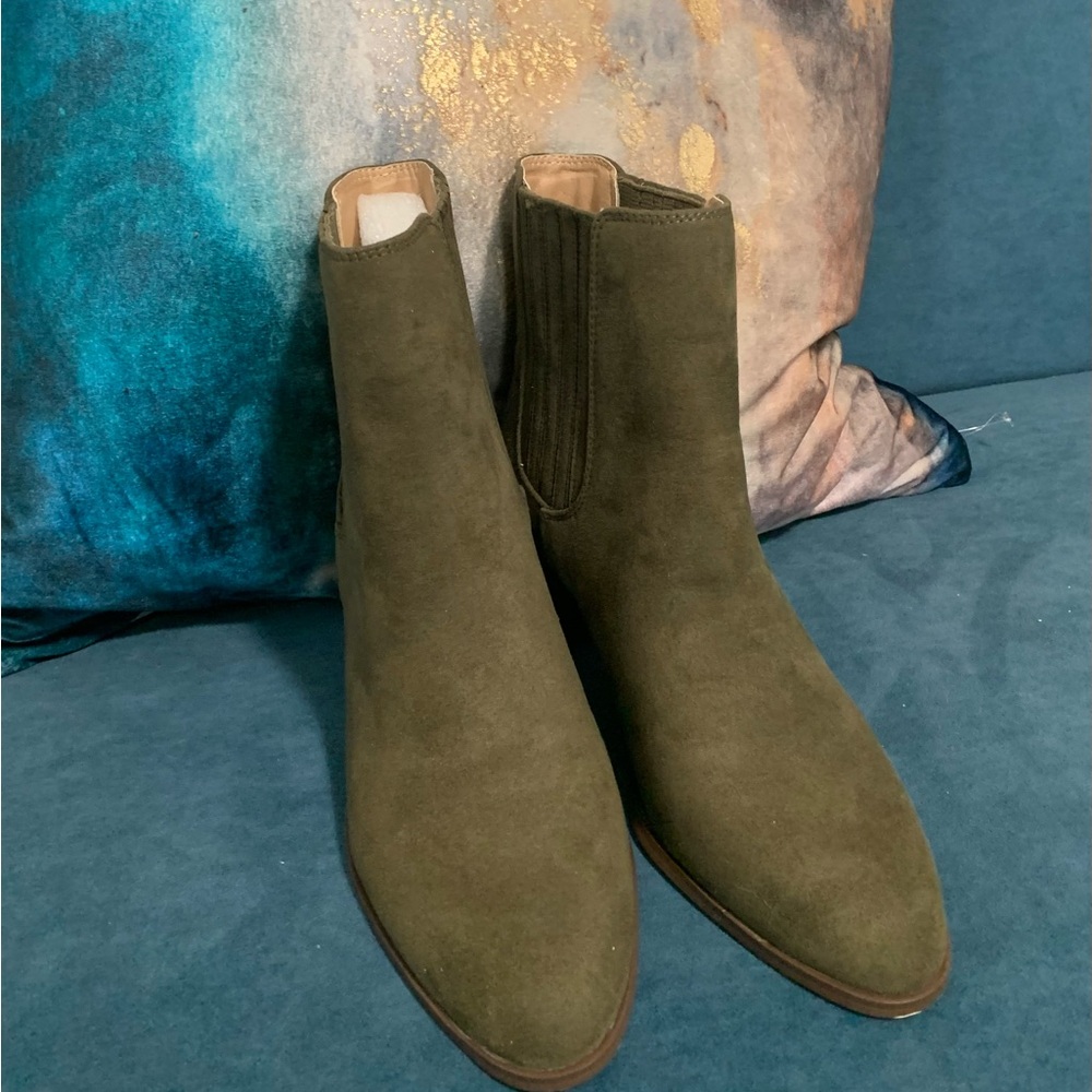 A new pair of olive green ankle boots in a chic Stacked Heel Chelsea style.